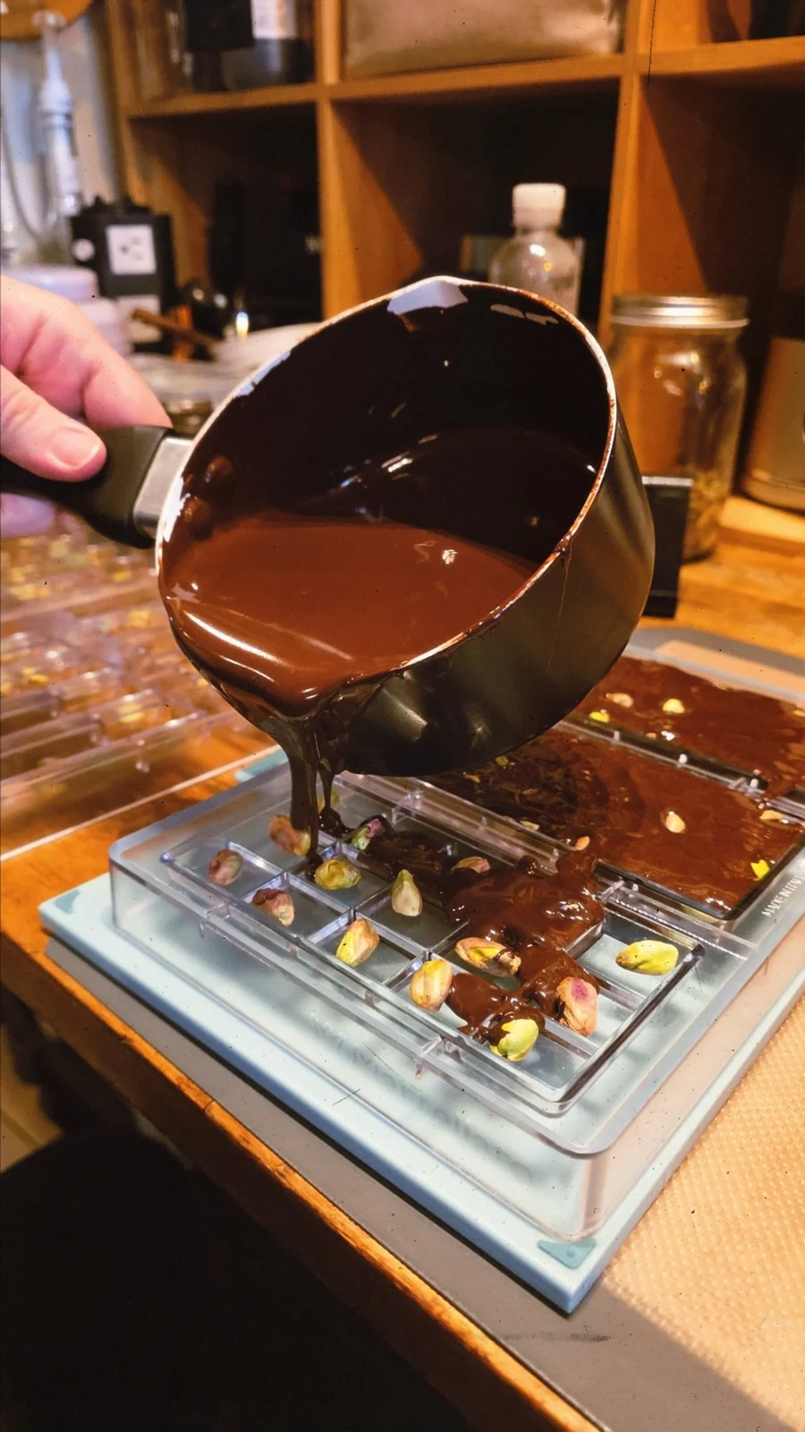 Hand-pouring melted chocolate into Bonibon molds